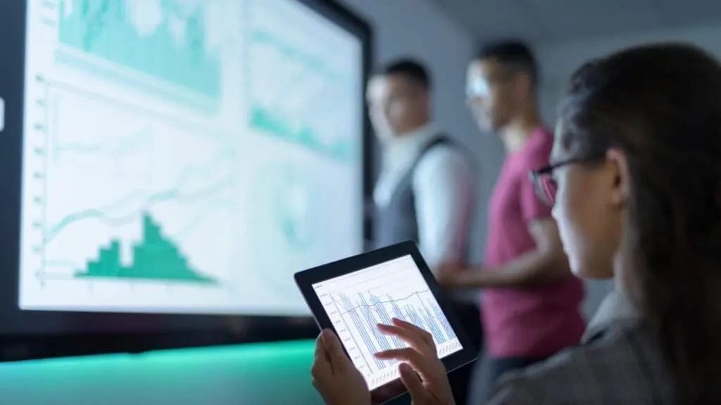 Businesswoman viewing graphs on digital tablet in business meeting